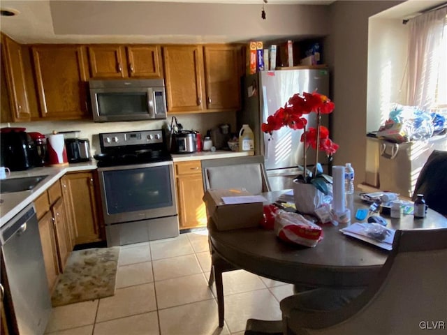 kitchen with light tile patterned floors and appliances with stainless steel finishes