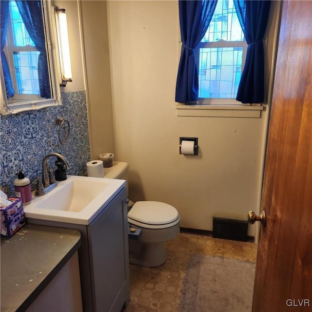 bathroom featuring vanity and toilet