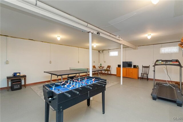 playroom with finished concrete floors and baseboards