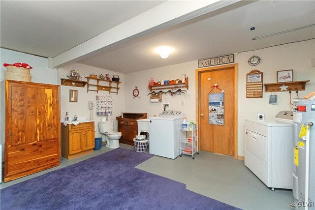 laundry room featuring washer / dryer, water heater, and a sink