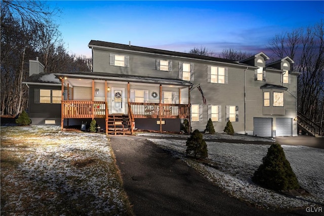 view of front of home with a porch and a garage