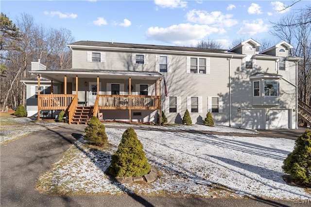 view of front of home featuring a porch and a garage