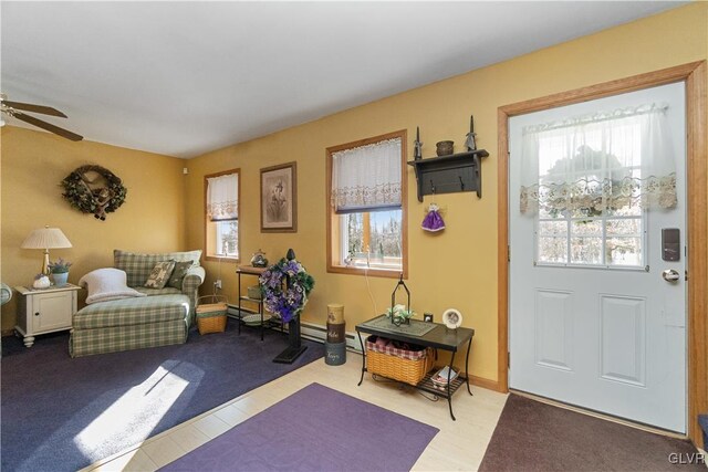 carpeted foyer with ceiling fan