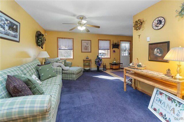 carpeted living room featuring a ceiling fan and baseboards