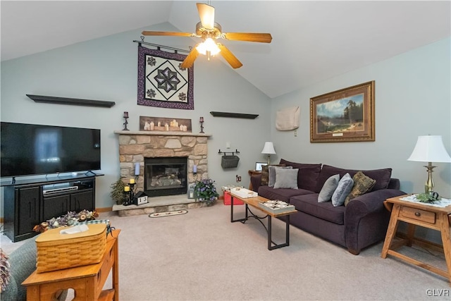 living room with light colored carpet, vaulted ceiling, ceiling fan, and a stone fireplace