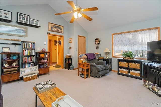 living room featuring carpet floors, ceiling fan, high vaulted ceiling, and baseboards
