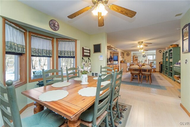 dining space featuring ceiling fan and light wood-style flooring