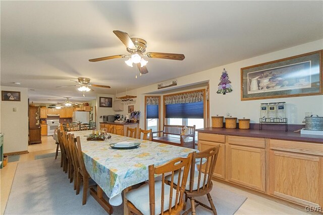 dining room featuring a ceiling fan and light wood-style flooring