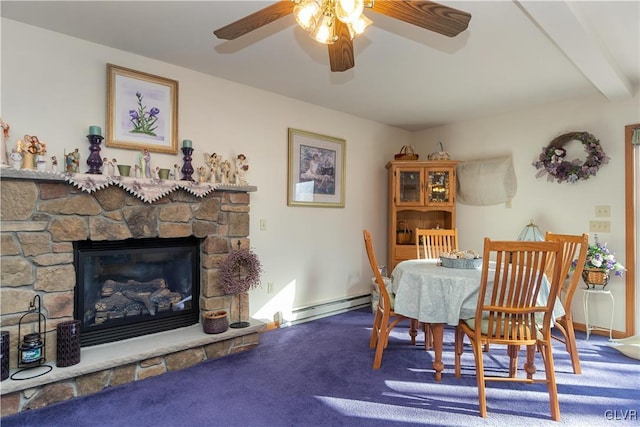 dining space with ceiling fan, a baseboard heating unit, beam ceiling, carpet floors, and a stone fireplace