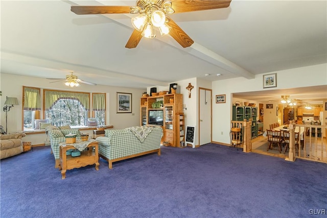 living room with beamed ceiling, carpet floors, and ceiling fan