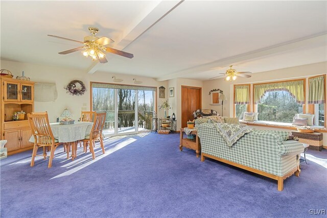 living room with ceiling fan, carpet floors, and beam ceiling