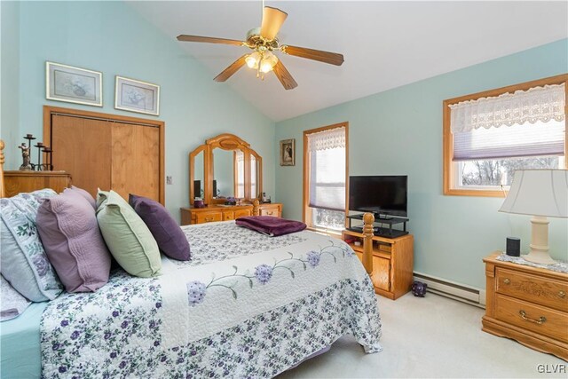 bedroom featuring a baseboard heating unit, lofted ceiling, light carpet, a ceiling fan, and a closet