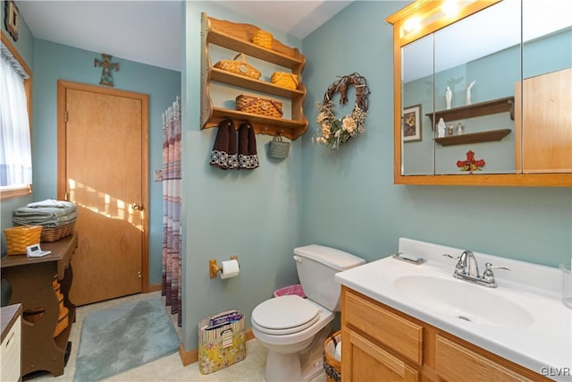 bathroom with tile patterned floors, vanity, and toilet