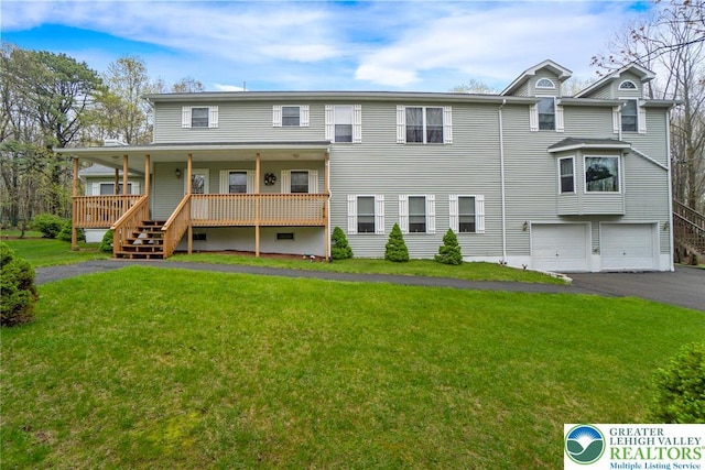 multi unit property featuring driveway, a front lawn, a garage, and covered porch