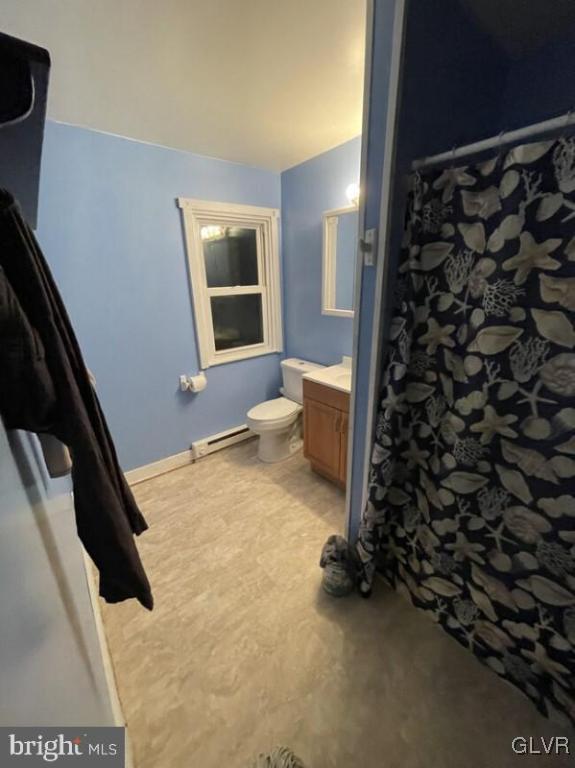 bathroom featuring vanity, toilet, and a baseboard radiator