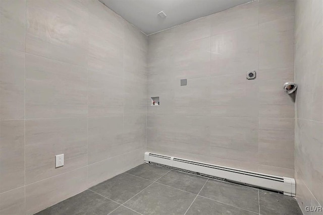 washroom featuring tile patterned flooring, baseboard heating, and hookup for a washing machine