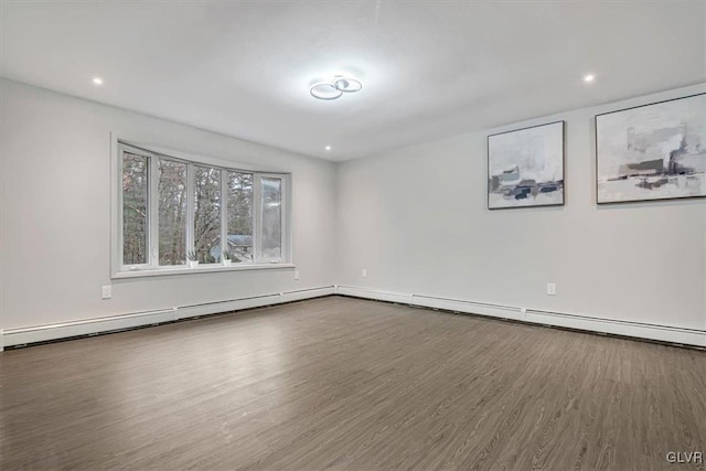 empty room with a baseboard radiator and hardwood / wood-style flooring