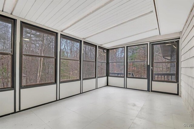 unfurnished sunroom featuring lofted ceiling