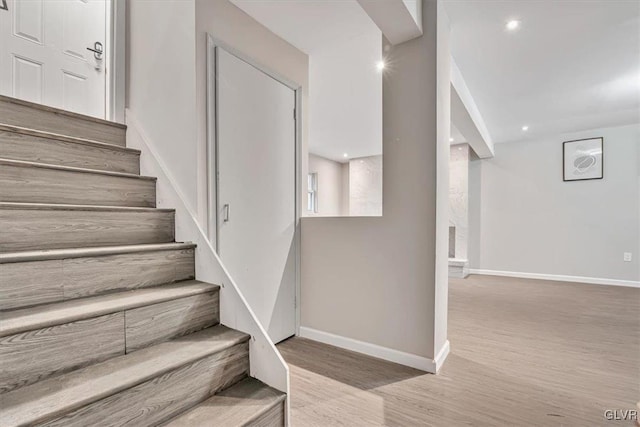 staircase with hardwood / wood-style flooring