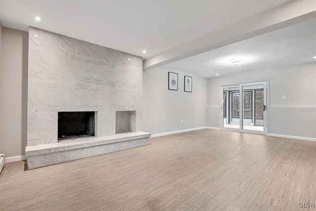 unfurnished living room featuring a fireplace and hardwood / wood-style flooring