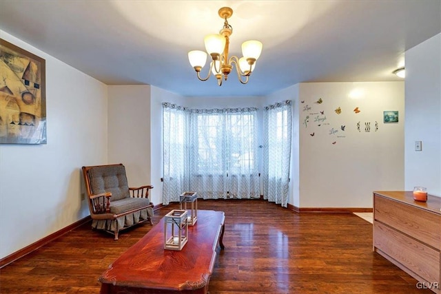 sitting room with a chandelier and dark hardwood / wood-style floors