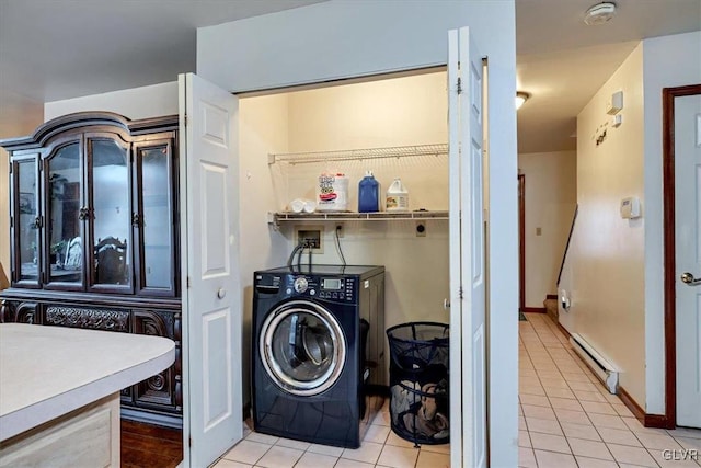 laundry area featuring baseboard heating, light tile patterned flooring, and independent washer and dryer