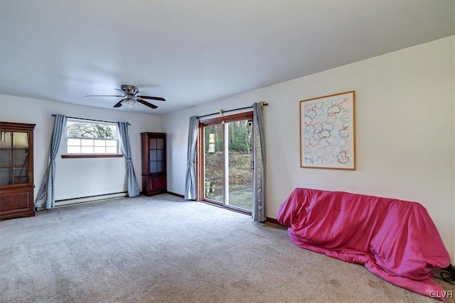 living room with plenty of natural light, light carpet, and a baseboard radiator