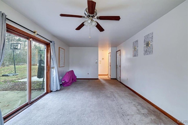 unfurnished room featuring ceiling fan and carpet floors