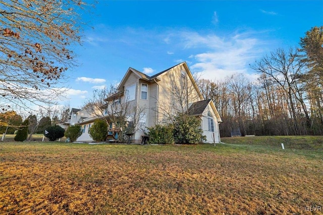 view of side of property with a lawn