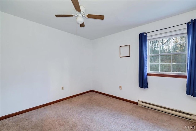 carpeted spare room featuring ceiling fan and a baseboard heating unit