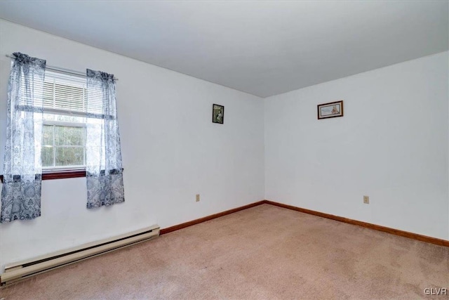 empty room with baseboard heating and carpet floors