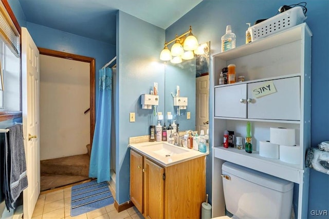 bathroom featuring tile patterned flooring, vanity, a shower with shower curtain, and toilet