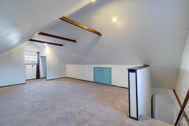 additional living space with light colored carpet and vaulted ceiling