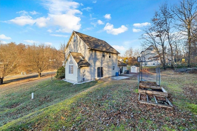 view of home's exterior with a lawn and a storage unit