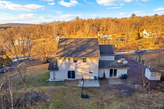 rear view of property featuring a patio area and a yard