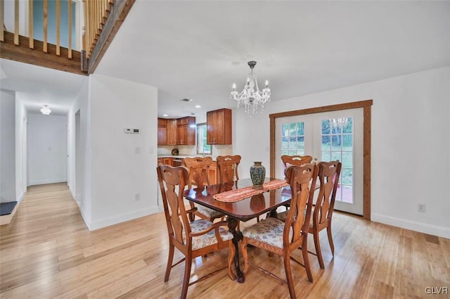 dining room featuring a chandelier and light wood-type flooring