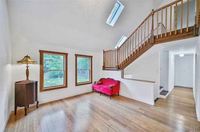 sitting room featuring light hardwood / wood-style floors and a skylight