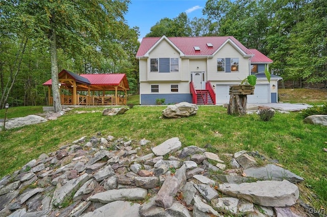 rear view of house featuring a yard and a garage