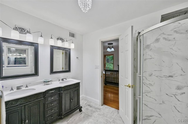 bathroom with vanity and a shower with door