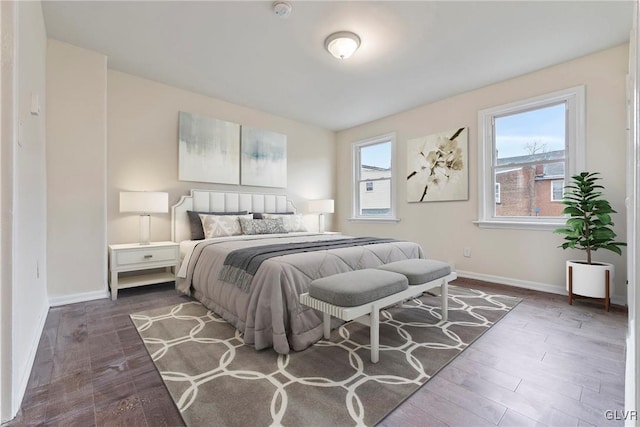 bedroom with dark hardwood / wood-style floors