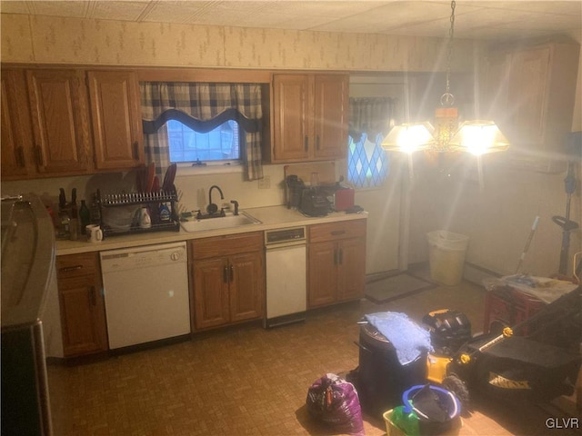 kitchen featuring pendant lighting, dishwasher, and sink