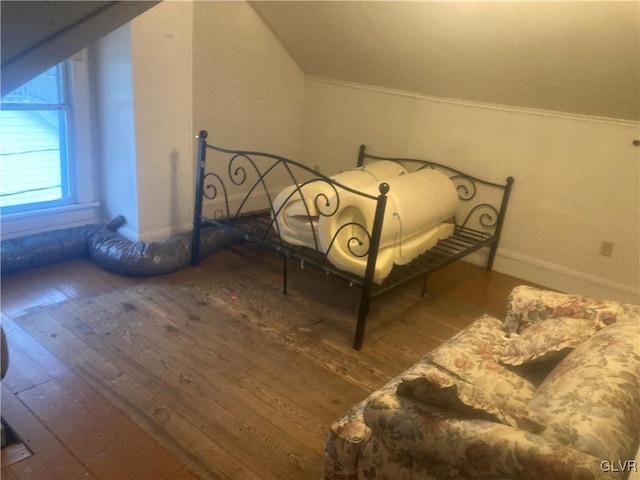 unfurnished bedroom featuring wood-type flooring and lofted ceiling