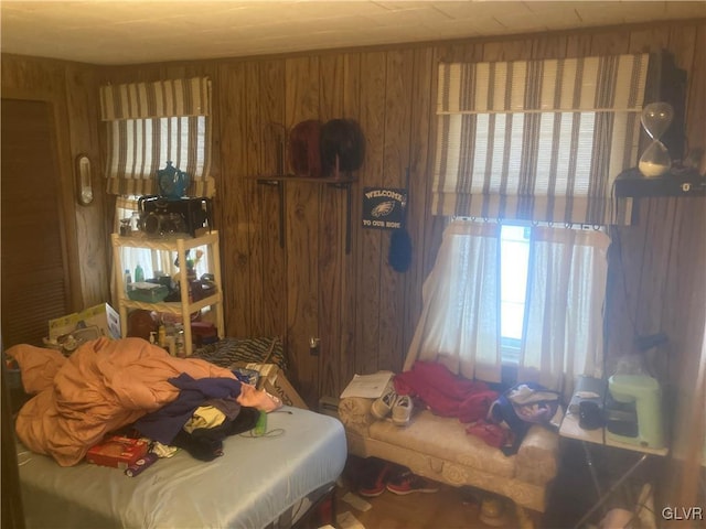 bedroom featuring wooden walls