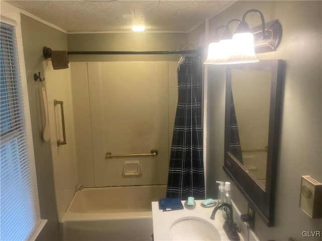 bathroom with bathtub / shower combination, a textured ceiling, and sink