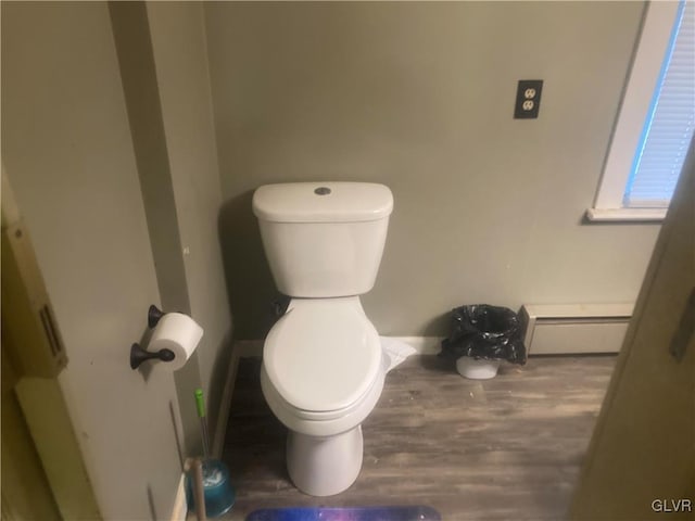 bathroom featuring toilet, wood-type flooring, and a baseboard radiator