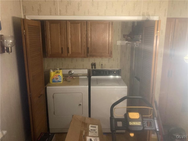 clothes washing area featuring cabinets and washing machine and dryer