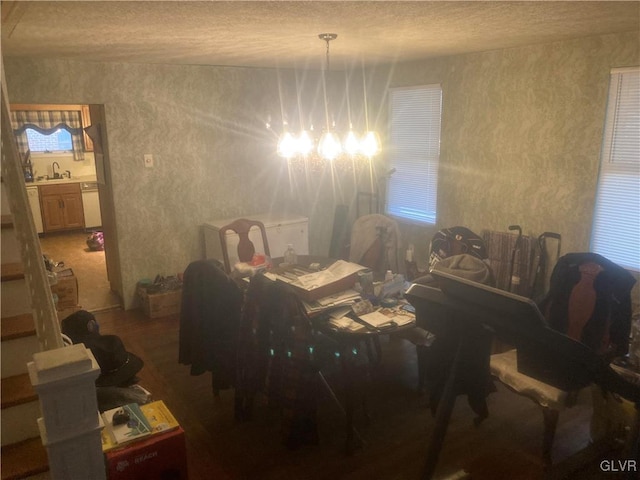 dining room with a textured ceiling, hardwood / wood-style flooring, and sink