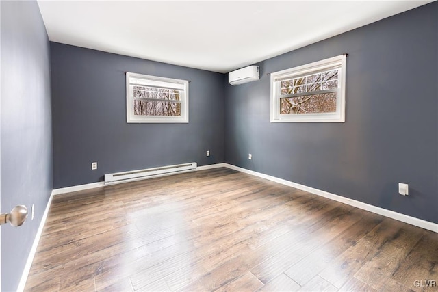 unfurnished room featuring baseboard heating, a wall mounted AC, plenty of natural light, and hardwood / wood-style floors