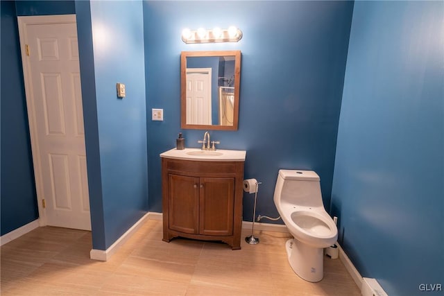 bathroom featuring vanity, a baseboard radiator, and toilet