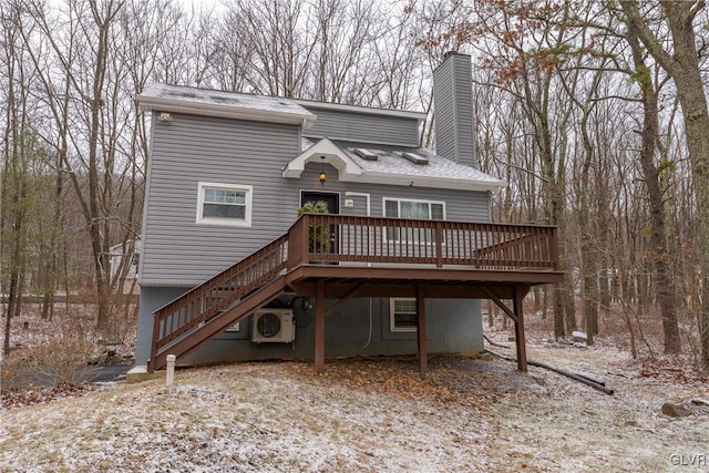 rear view of property with ac unit and a deck